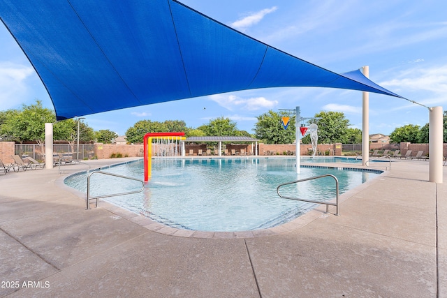 pool featuring fence and a patio
