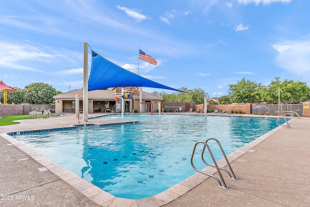 pool with fence and a patio area