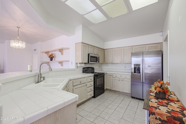 kitchen featuring tile countertops, light brown cabinets, appliances with stainless steel finishes, and hanging light fixtures