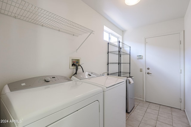 laundry area with light tile patterned floors and independent washer and dryer