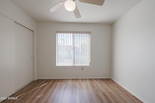 empty room with ceiling fan and hardwood / wood-style flooring