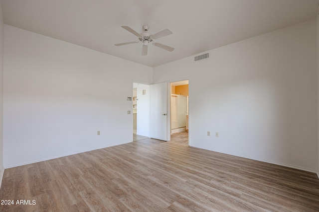 empty room with ceiling fan and light hardwood / wood-style flooring