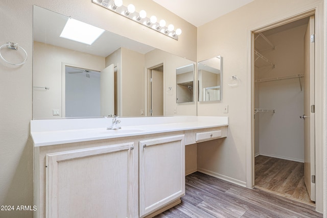 bathroom with vanity and hardwood / wood-style flooring