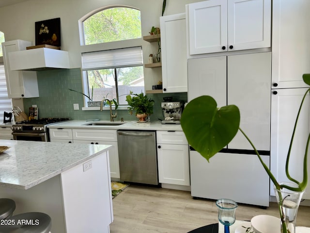 4925 W Bluefield Ave, Glendale, AZ 85308 - kitchen with appliances with stainless steel finishes, open shelves, white cabinets, tasteful backsplash, and light wood-style floors