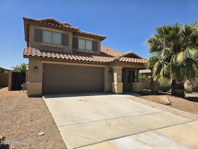 mediterranean / spanish-style house featuring a tiled roof, driveway, and stucco siding