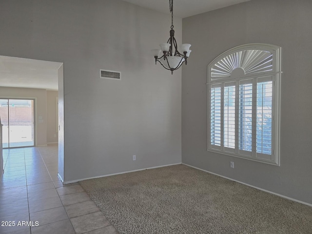 unfurnished room with baseboards, a chandelier, light tile patterned floors, and visible vents