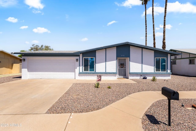2706 W Isabella Ave, Mesa, AZ 85202 - mid-century modern home featuring stucco siding, concrete driveway, and an attached garage