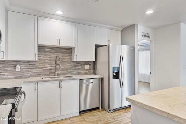 2706 W Isabella Ave, Mesa, AZ 85202 - kitchen featuring stainless steel appliances, white cabinets, light wood-style floors, backsplash, and a ceiling fan
