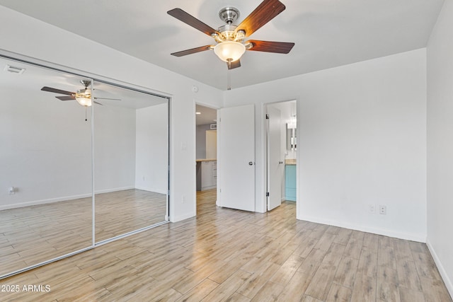 2706 W Isabella Ave, Mesa, AZ 85202 - unfurnished bedroom with wood finished floors, a closet, a ceiling fan, and ensuite bathroom