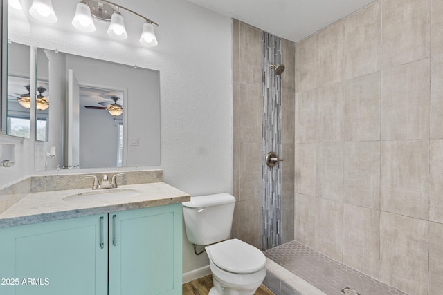 2706 W Isabella Ave, Mesa, AZ 85202 - bathroom with a tile shower, vanity, a ceiling fan, a textured wall, and wood finished floors