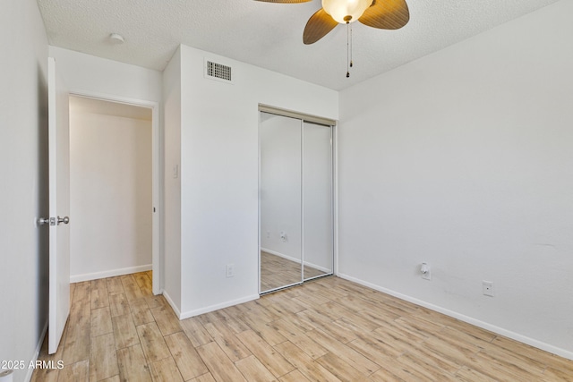 2706 W Isabella Ave, Mesa, AZ 85202 - unfurnished bedroom with wood finished floors, a closet, a ceiling fan, and a textured ceiling