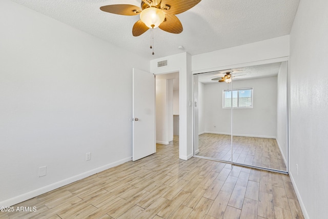 2706 W Isabella Ave, Mesa, AZ 85202 - unfurnished bedroom with light wood-style floors, a textured ceiling, ceiling fan, and a closet