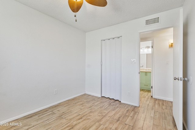 2706 W Isabella Ave, Mesa, AZ 85202 - unfurnished bedroom featuring light wood finished floors, a closet, a textured ceiling, and a ceiling fan