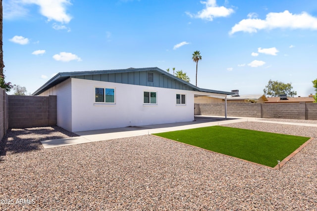 2706 W Isabella Ave, Mesa, AZ 85202 - back of house with board and batten siding, a fenced backyard, and a patio area