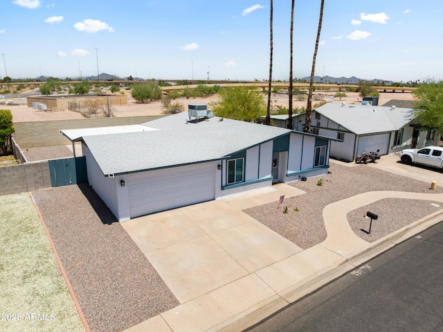2706 W Isabella Ave, Mesa, AZ 85202 - view of front facade with a garage, concrete driveway, a shingled roof, and a mountain view