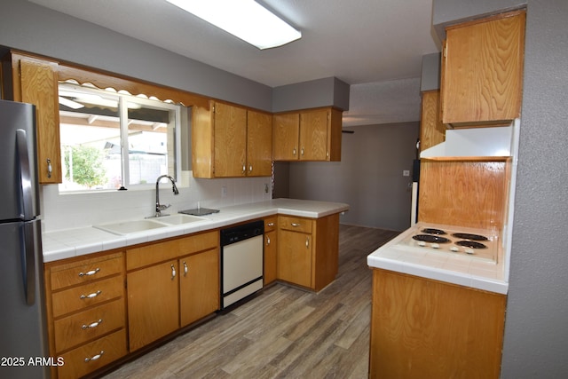 5720 E University Dr, Mesa, AZ 85205 - kitchen featuring white appliances, a sink, light wood finished floors, backsplash, and brown cabinetry