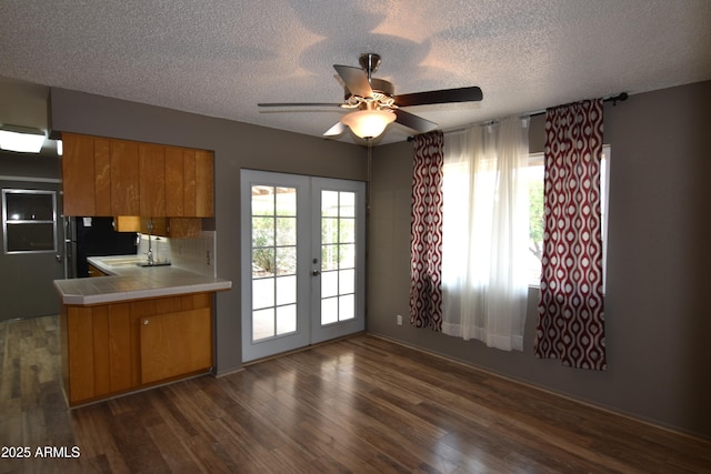 5720 E University Dr, Mesa, AZ 85205 - kitchen featuring tile counters, french doors, brown cabinets, ceiling fan, and a textured ceiling