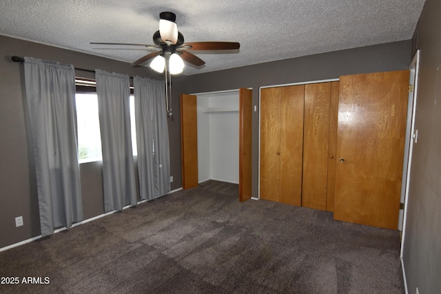 5720 E University Dr, Mesa, AZ 85205 - unfurnished bedroom featuring a textured ceiling, carpet floors, multiple closets, and a ceiling fan