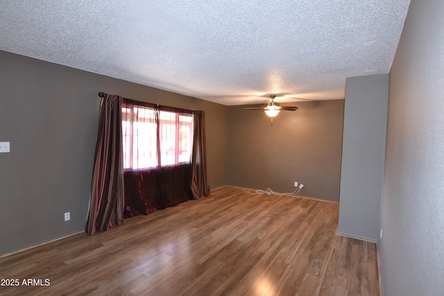 5720 E University Dr, Mesa, AZ 85205 - unfurnished room with wood finished floors, a ceiling fan, and a textured ceiling