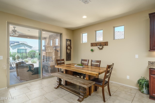 tiled dining area featuring ceiling fan and plenty of natural light