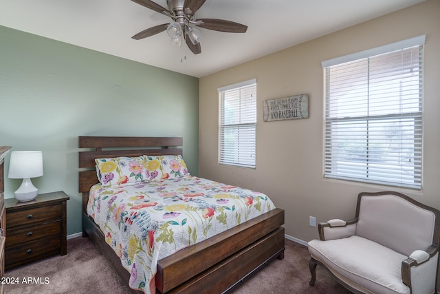 bedroom with dark colored carpet and ceiling fan