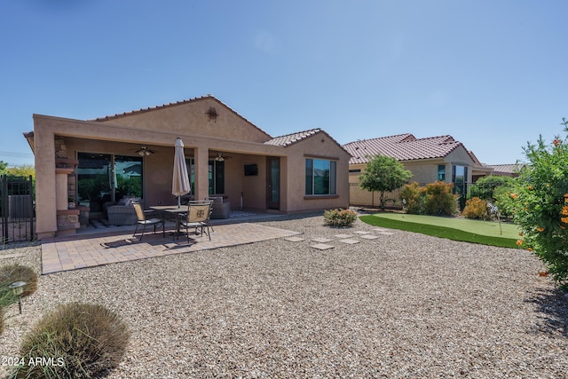 back of property with a patio area and ceiling fan