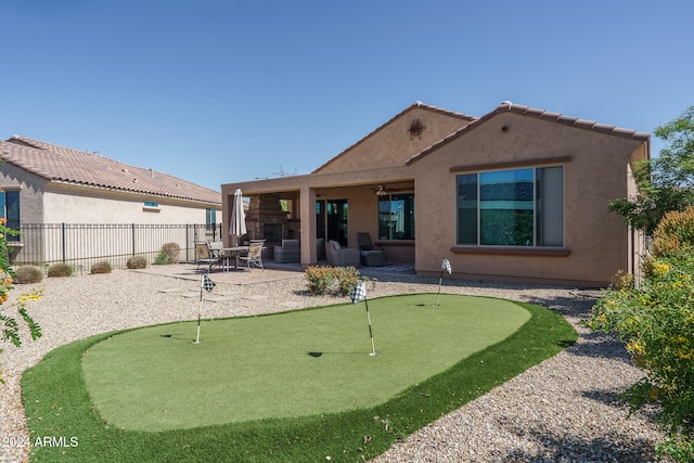 rear view of property with a patio area and ceiling fan