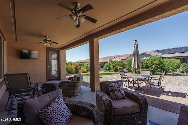 view of patio / terrace with ceiling fan and an outdoor living space