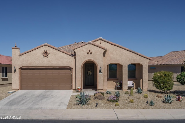 26404 W Zachary Dr, Buckeye, AZ 85396 - mediterranean / spanish-style home featuring stucco siding, an attached garage, a tiled roof, and concrete driveway