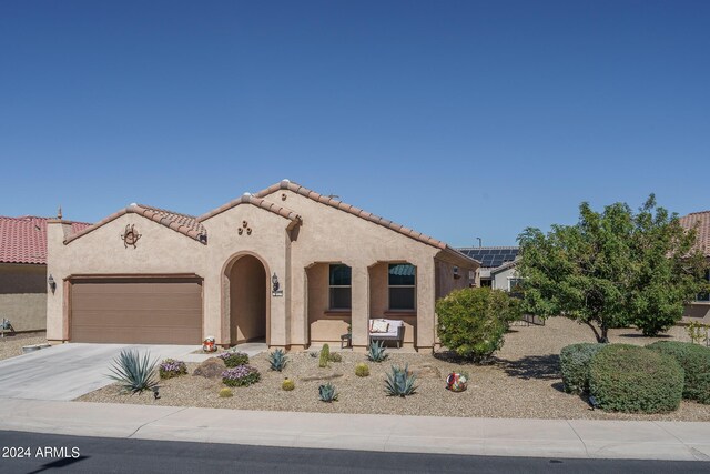 26404 W Zachary Dr, Buckeye, AZ 85396 - mediterranean / spanish-style house featuring stucco siding, an attached garage, a tiled roof, and concrete driveway