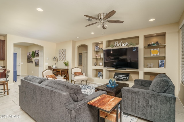 living room with light tile patterned flooring, built in features, and ceiling fan