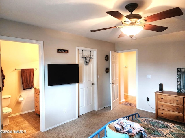 carpeted bedroom featuring ceiling fan and connected bathroom