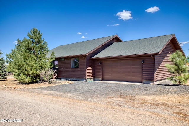 log cabin featuring a garage