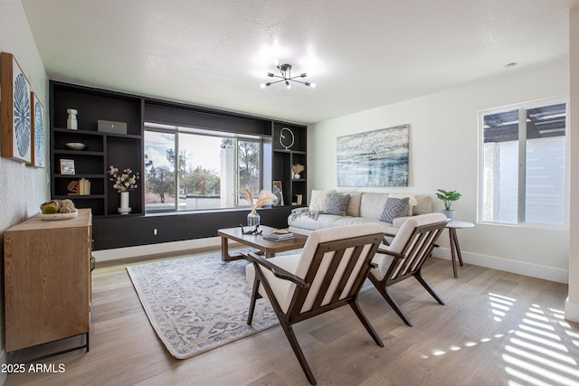 living room with light hardwood / wood-style floors and a textured ceiling