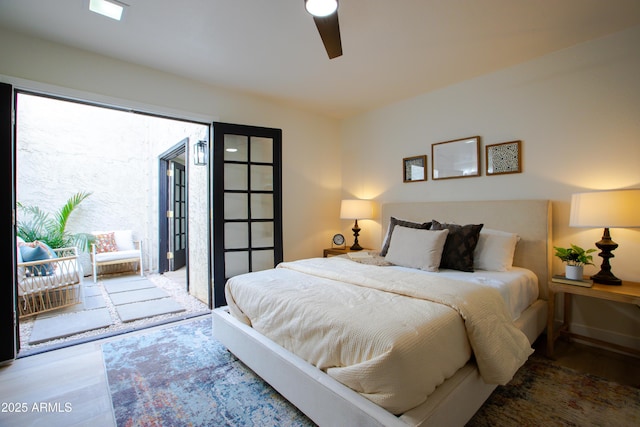 bedroom featuring hardwood / wood-style flooring, access to outside, and ceiling fan