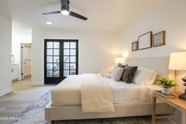 bedroom with french doors, ensuite bathroom, ceiling fan, and light hardwood / wood-style flooring