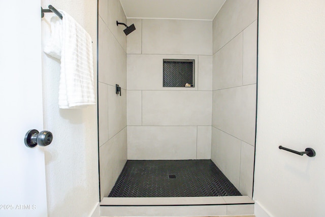 bathroom with tiled shower