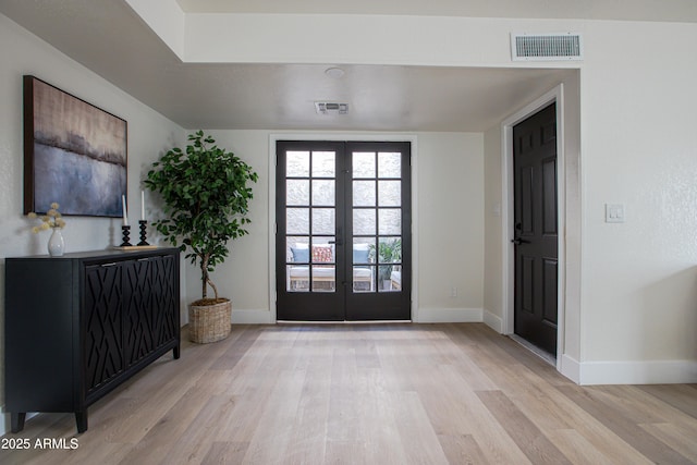 entryway featuring light hardwood / wood-style floors and french doors