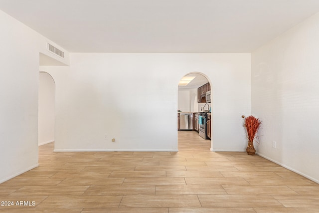 spare room featuring light hardwood / wood-style floors