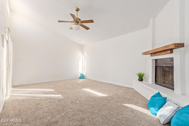 unfurnished living room with ceiling fan, light colored carpet, a fireplace, and vaulted ceiling