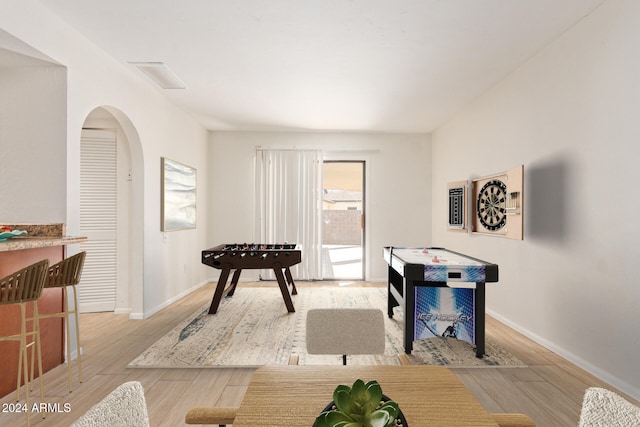 game room with light hardwood / wood-style floors