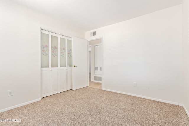 unfurnished bedroom featuring a closet and carpet flooring