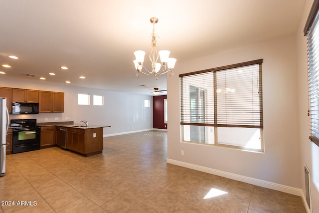 kitchen featuring black appliances, sink, ceiling fan with notable chandelier, kitchen peninsula, and pendant lighting