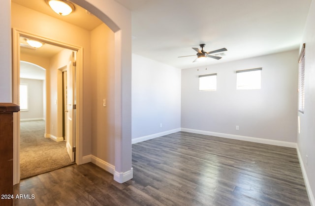 spare room featuring dark hardwood / wood-style floors and ceiling fan