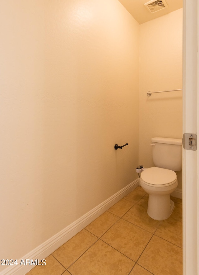 bathroom with toilet and tile patterned flooring