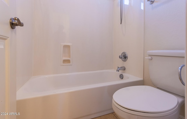 bathroom with shower / washtub combination, toilet, and tile patterned floors