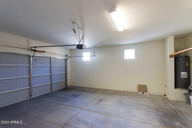 garage with a garage door opener and electric water heater