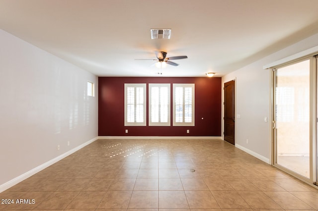 empty room featuring light tile patterned floors and ceiling fan