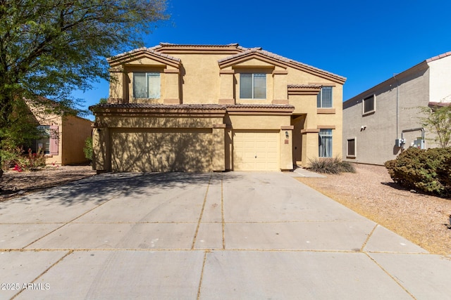 mediterranean / spanish-style house featuring a garage, a tiled roof, concrete driveway, and stucco siding