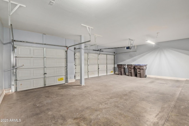 garage with a garage door opener and baseboards